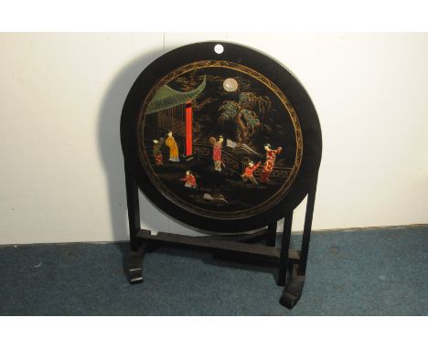A small vintage Chinese lacquered occasional table, having circular top with inlaid and painted scene, on folding base 
