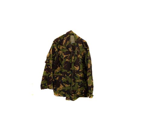 A British Army camouflage combat smock, together with snow camouflage jacket and trousers, plus a desert rat camouflage top a
