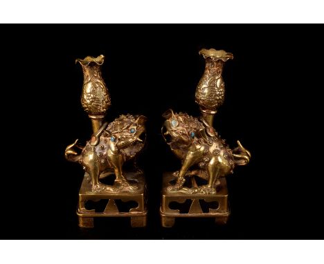 A pair of vintage Indian brass candle holders, in the form of Chinese temple dogs with turquoise bead eyes (2) 