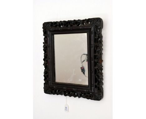A Chinese hardwood frame, now centred with a mirror, the frame with simulated bamboo and blossom surround, 35cm by 31cm  