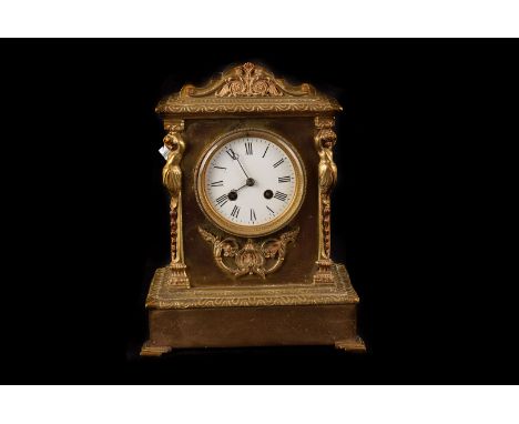 A late Victorian brass mantle clock, having white enamel dial in architectural brass case with eight day movement 
