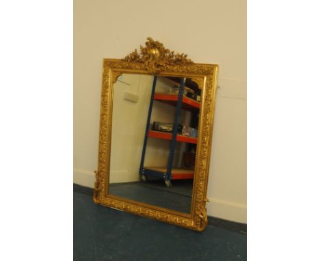 A large gilt mirror, with C scroll "camel hump" upper and ornate surround, 139cm high 