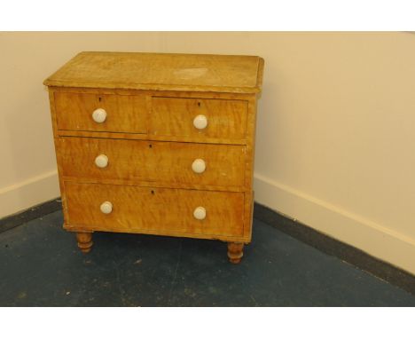 A small Victorian stripped pine chest of drawers, having later ceramic knobs, AF, 84cm wide 