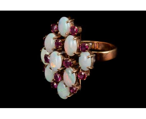 An opal and garnet dress ring, the nine oval cut opals with small round cut garnets set between, in high setting, on yellow m