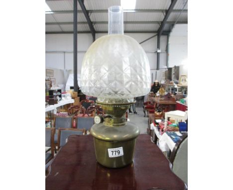 A brass Hinks drop in oil lamp font with shade and chimney
