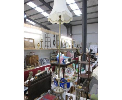 A decorative standard lamp with shade