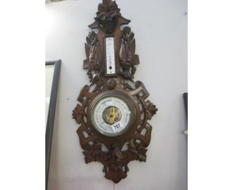A French barometer featuring a wolf's head and birds