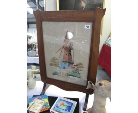 An fire screen with emroidered panel