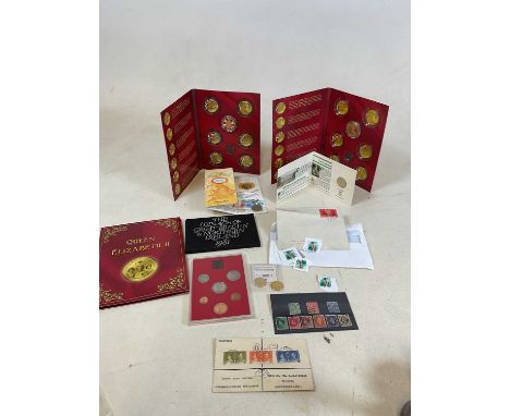 A collection of coins and stamps including The Coinage of Great Britain and Northern Ireland 1982, the Bill of Rights £2 comm