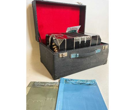A cased accordion with music booklets.