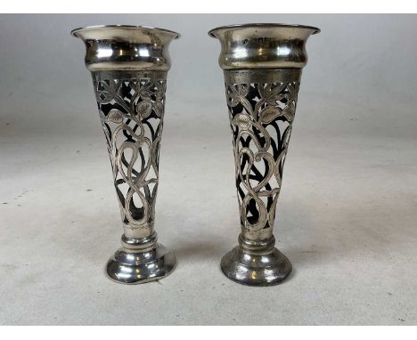 GOLDSMITHS &amp; SILVERSMITHS CO; a pair of Edwardian hallmarked loaded silver vases, designed to house glass liners and with
