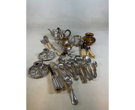 A collection of silver plated items and cutlery and flatware to include a pair of chamber candlesticks, a tea set, a candle s