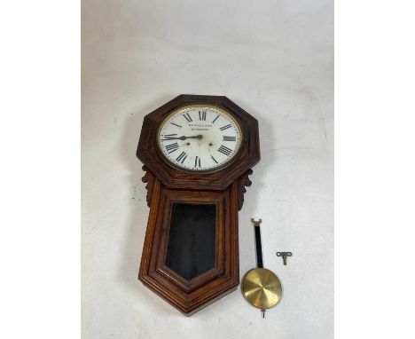 An oak wall clock with octagonal case and circular dial set with Roman numerals and inscribed 'Walford &amp; Son, Banbury', l