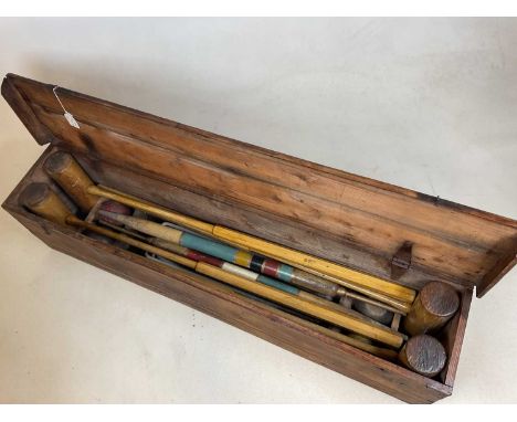 A pine cased vintage croquet set comprising 4 mallets, 4 balls, 2 pegs and various hoops, length of case 114cm