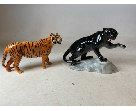 BESWICK; a model of a puma on rock, 1702, also standing tiger (2).Condition Report: Tip of front left paw of tiger has been b