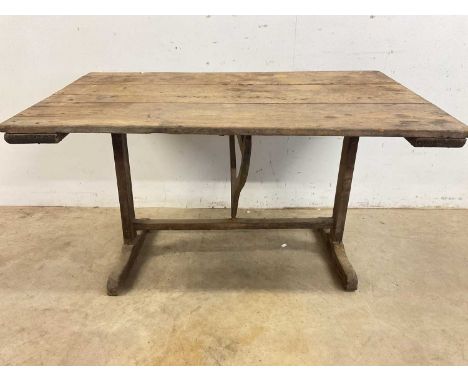 A French vintage wine maker's table, with tilt-top and folding stretcher support bar, height 69cm, width 132cm, depth 79cm.