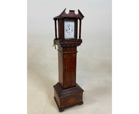 A miniature longcase clock in an inlaid mahogany case, the face marked Benton, Regent Street London, with winder, height 56cm