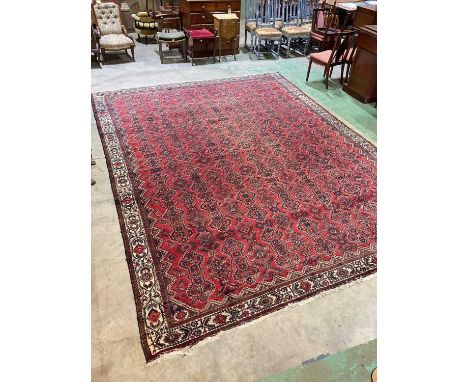 Large Persian Bendarian wool carpet red ground and cream border, 407cm x 308cmCondition Report: Overall good condition slight