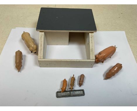 A group of painted lead pigs comprising 2 boars, 2 sows and 3 piglets, a trough and a simple wooden sty, two of the figures s