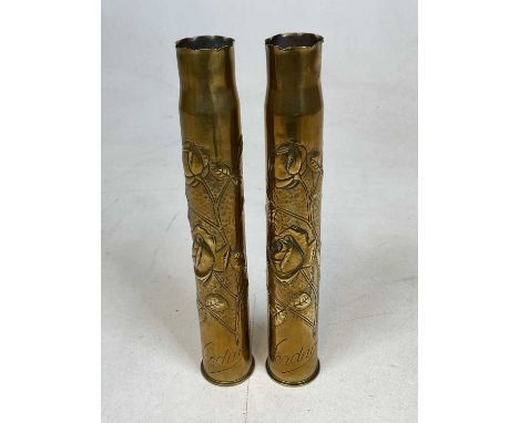 A pair of World War 1 period brass 'Trench Art' shells with rose embossed detail and both inscribed 'Verdun', height 37.5cm. 