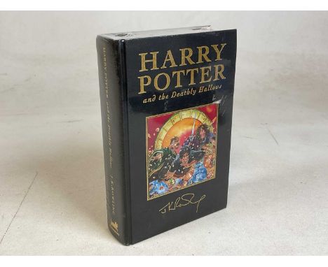 A hardbound First Edition copy of Harry Potter and the Deathly Hallows, shrink wrapped.