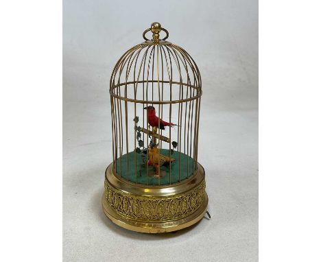 A 20th century brass bird cage automaton with yellow and red feathered birds with foliage, winding key to base, 27cm x 17cm.C
