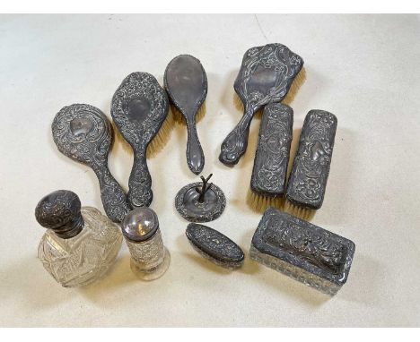 A group of hallmarked silver backed hand mirror, hand and clothes brushes, with silver mounted dressing table bottles, trinke