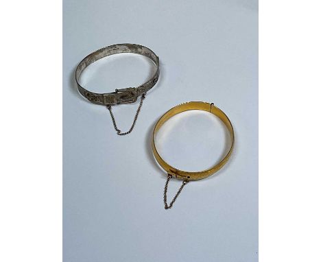 An Elizabeth II hallmarked silver bangle, Birmingham, 1973 and a gold plated bangle (2)