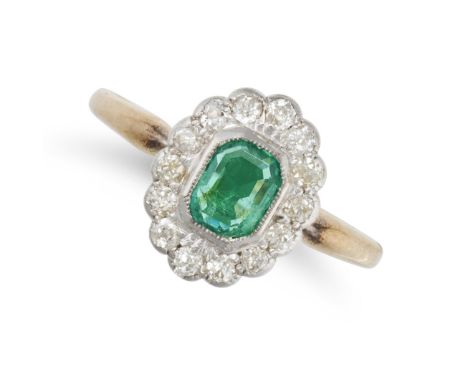 AN EMERALD AND DIAMOND CLUSTER RING in 18ct yellow gold, set with an octagonal step cut emerald in a cluster of old cut diamo