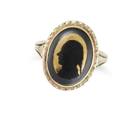 AN ANTIQUE ENAMEL SILHOUETTE RING in yellow gold, the oval face decorated with the silhouette of a man in black enamel, benea