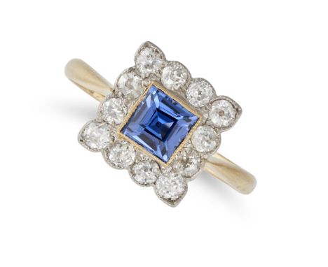 A SAPPHIRE AND DIAMOND CLUSTER RING in 18ct yellow gold, set with a square step cut sapphire of approximately 0.65 carats in 