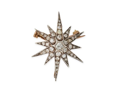 AN ANTIQUE DIAMOND STAR BROOCH / PENDANT in yellow gold and silver, designed as a twelve rayed star, set throughout with old 