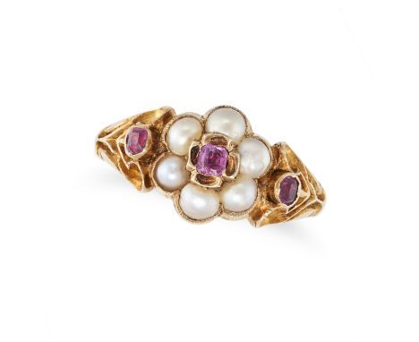 AN ANTIQUE RUBY AND PEARL RING in yellow gold, set with a cushion cut ruby in a cluster of pearls, accented by further cushio