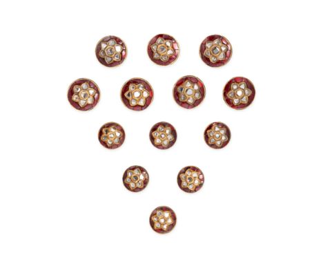 A SET OF RUBY, DIAMOND AND ENAMEL BUTTONS in yellow gold, comprising thirteen buttons each set with a cluster of polki cut di