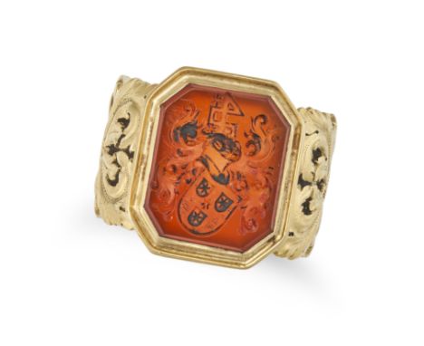 AN ANTIQUE CARNELIAN SIGNET RING in yellow gold, set with an octagonal carnelian intaglio carved to depict a coat of arms, th