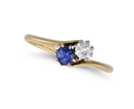 A SAPPHIRE AND DIAMOND RING in 18ct yellow gold, in crossover design, set with a round cut sapphire and an old cut diamond, s