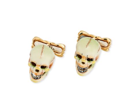 A PAIR OF ENAMEL SKULL CUFFLINKS in 18ct yellow gold, each designed as a skull decorated with white, yellow, orange and green