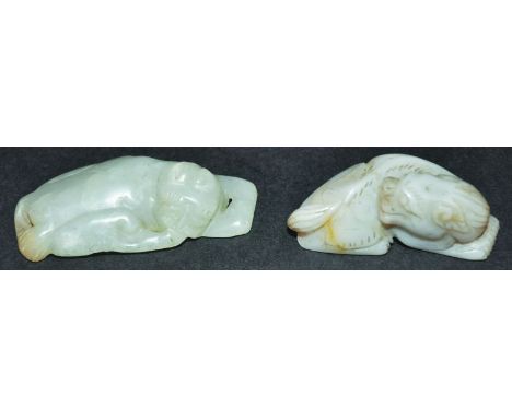 TWO CHINESE JADE CARVINGS, each of a buddhistic lion, 2.7in & 2.25in long. (2)