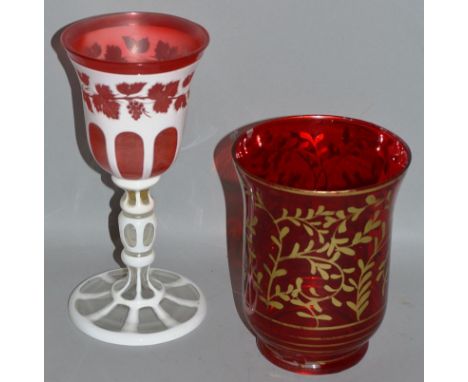 A BOHEMIAN RUBY AND WHITE OVERLAY GOBLET and a ruby etched vase (2).