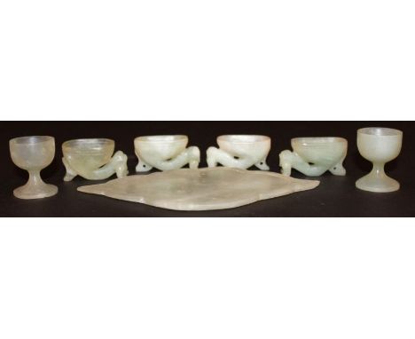 A GROUP OF 20TH CENTURY CHINESE CELADON-GREEN JADE-LIKE ITEMS, including an undecorated shaped plaque, a pair of wine cups, a