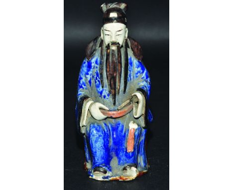 A CHINESE GLAZED CERAMIC FIGURE OF A SEATED SAGE, 7.75in high. 