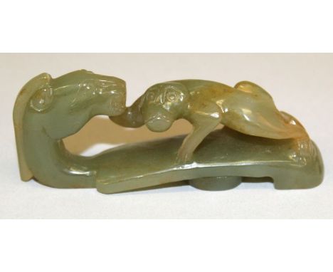  A CHINESE JADE BELT HOOK, the stone of dark green celadon tone with brown inclusions, 3.4in long.