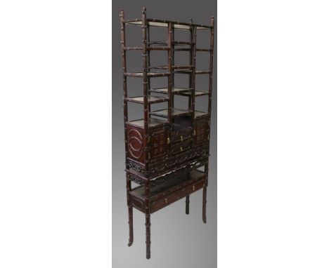 A 19TH CENTURY CHINESE REDWOOD TWO TIER OPEN SET OF SHELVES, the top with a pair of panel doors with calligraphy and small dr