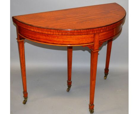 A GOOD SHERATON REVIVAL DEMI-LUNE CARD TABLE of superb colour with folding top, green baize interior, supported on tapering l