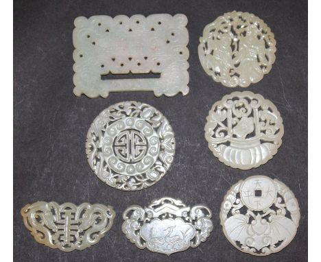 A GROUP OF SEVEN PIERCED CHINESE JADE-LIKE PENDANTS, the largest 3.1in x 2.2in. (6)