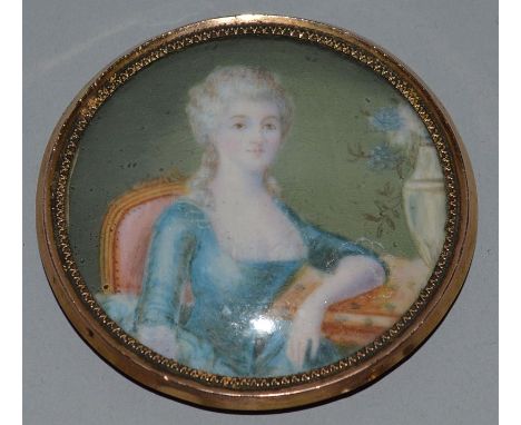 A CIRCULAR PORTRAIT OF A YOUNG LADY seated in a chair. 2.25ins diameter.