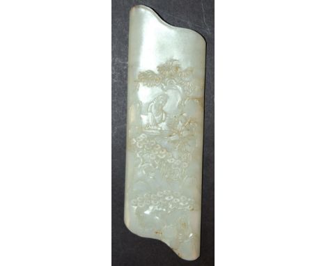 A CHINESE CARVED AND SHAPED-END CELADON-GREEN JADE PLAQUE, carved in low relief with a sage in a grove of pine and rockwork, 