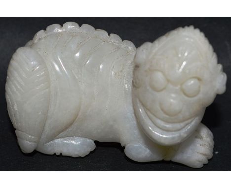A CHINESE CARVED WHITE JADE DOG OF FOE. 2ins long.