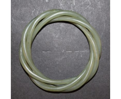 A CHINESE GREEN JADE-LIKE THREE-STRAND BANGLE, approx. 3.1in diameter, the inner rim approx. 2.1in diameter.