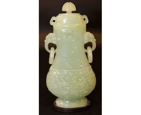 A CHINESE CELADON GREEN JADE-LIKE VASE & COVER, together with a fixed wood stand, the vase of archaic form and design and wi